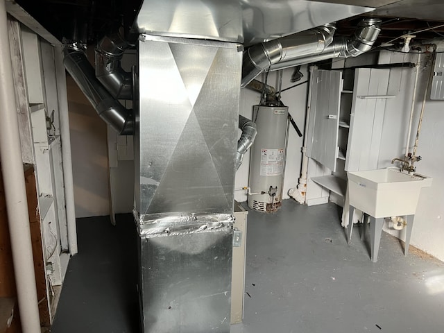 utilities with gas water heater, heating unit, and a sink
