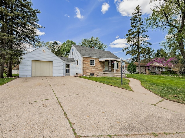 bungalow-style home with an attached garage, a front yard, concrete driveway, and roof with shingles