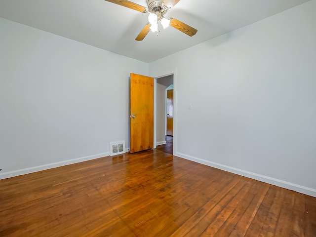 empty room featuring baseboards, hardwood / wood-style flooring, and a ceiling fan
