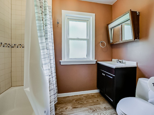 full bathroom featuring toilet, vanity, baseboards, and shower / tub combo with curtain