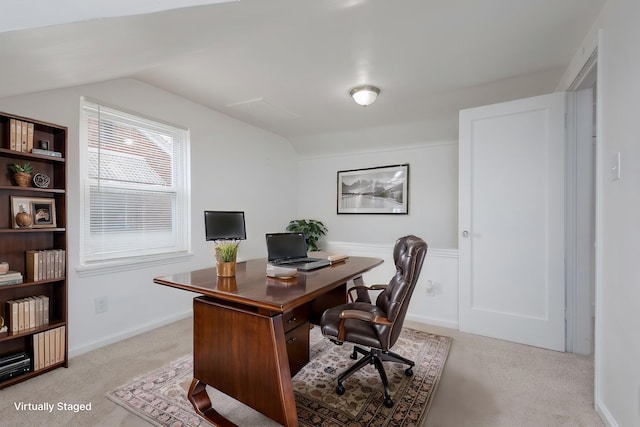 office area featuring light carpet and lofted ceiling