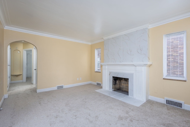 unfurnished living room with carpet flooring, visible vents, and crown molding