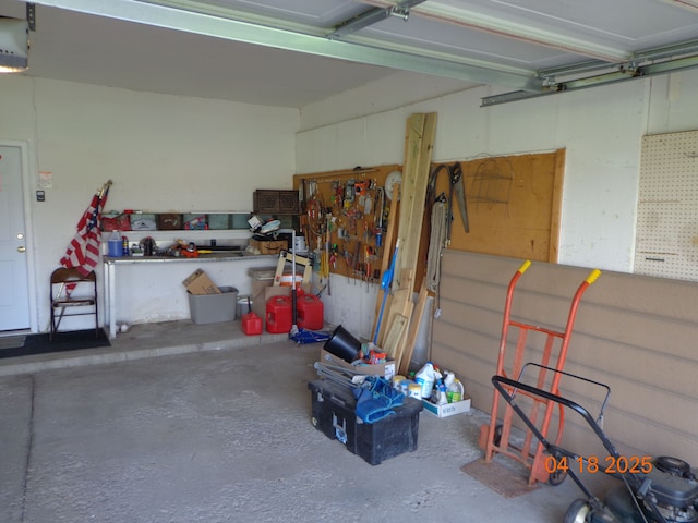 garage with a garage door opener and a workshop area