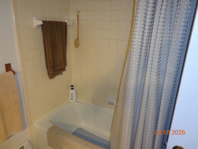 full bathroom featuring a baseboard heating unit and shower / tub combo