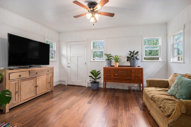 living room with a wealth of natural light, wood finished floors, and ceiling fan