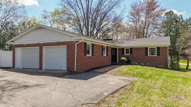 single story home with a front yard and brick siding