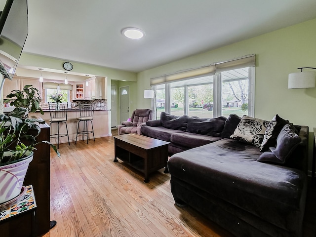 living area with plenty of natural light and light wood-style flooring