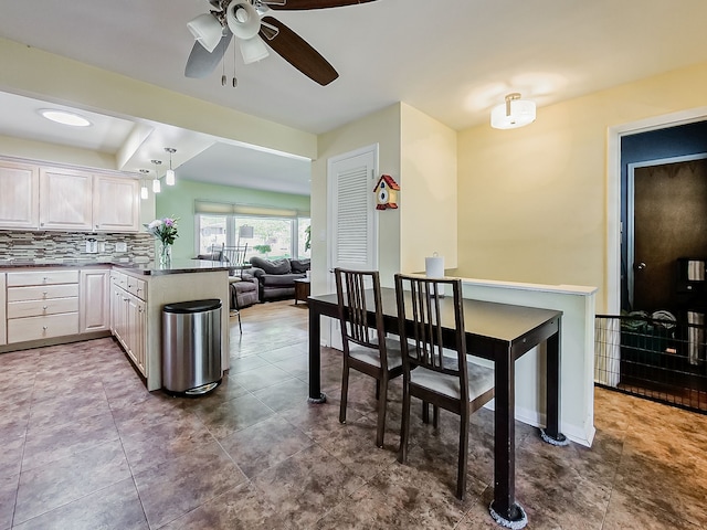 dining space featuring baseboards and ceiling fan