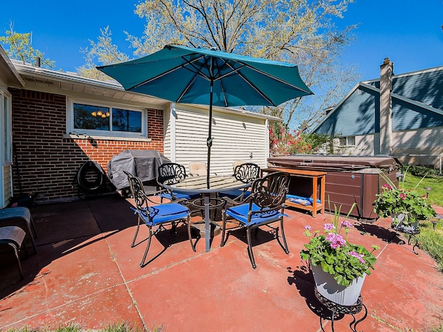 view of patio / terrace with a hot tub and area for grilling