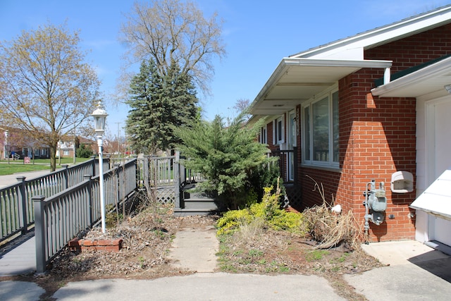 33185 Swallow Dr, Rockwood, MI 48173 - view of side of home with a deck and brick siding