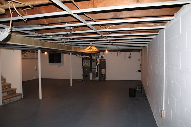 33185 Swallow Dr, Rockwood, MI 48173 - unfinished basement with gas water heater, heating unit, concrete block wall, and stairs