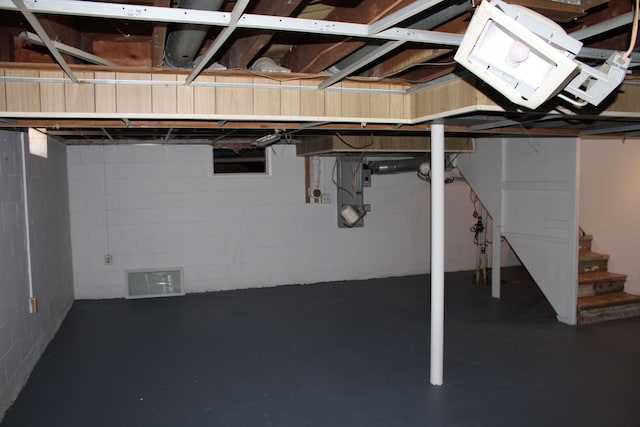 33185 Swallow Dr, Rockwood, MI 48173 - unfinished basement featuring stairway, visible vents, and concrete block wall