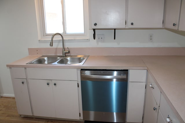 33185 Swallow Dr, Rockwood, MI 48173 - kitchen featuring white cabinets, stainless steel dishwasher, light countertops, and a sink
