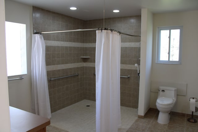 33185 Swallow Dr, Rockwood, MI 48173 - bathroom with tile patterned floors, a tile shower, toilet, and recessed lighting