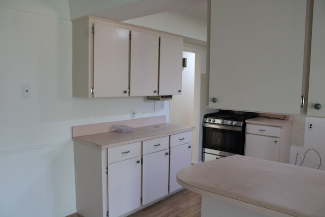 33185 Swallow Dr, Rockwood, MI 48173 - kitchen featuring stainless steel gas stove, light wood finished floors, white cabinets, and light countertops