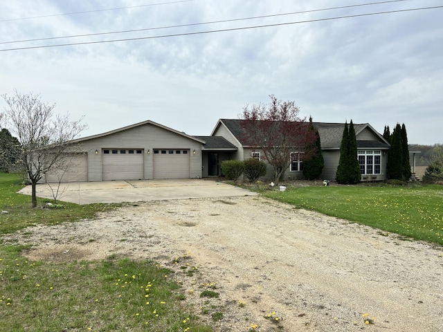 ranch-style house with concrete driveway, a front yard, and an attached garage
