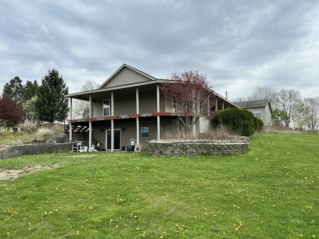 rear view of property featuring a deck and a lawn