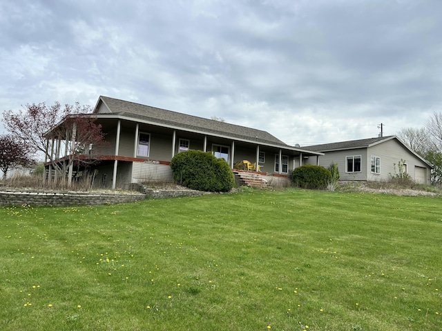 rear view of property with a yard and a porch