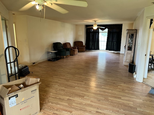 sitting room featuring ceiling fan, baseboards, light wood-style flooring, and visible vents