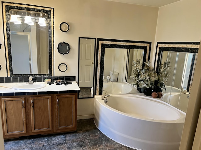 bathroom featuring stone finish flooring, a garden tub, vanity, and a shower stall