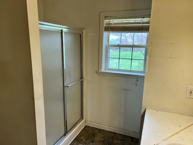 bathroom featuring a shower with shower door