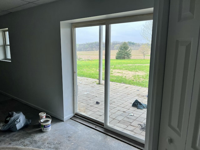 doorway with baseboards and a rural view