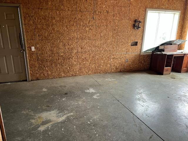 empty room with unfinished concrete flooring