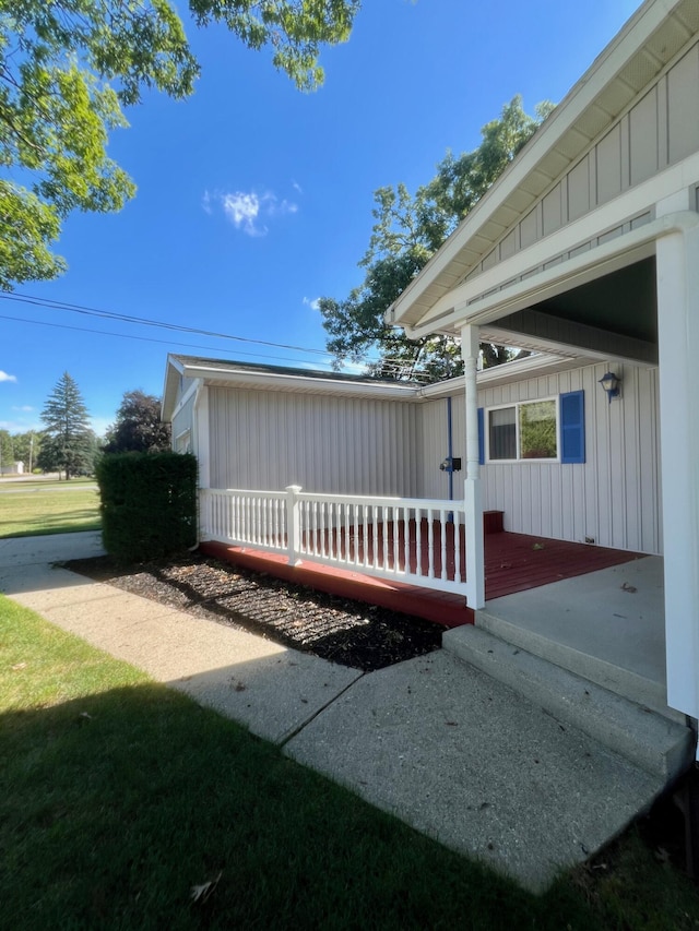 exterior space featuring board and batten siding and a wooden deck