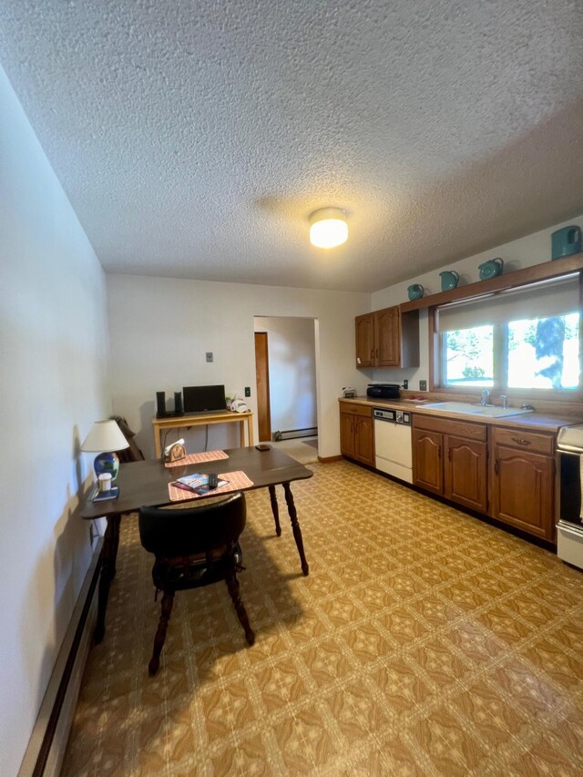 kitchen featuring stove, brown cabinets, dishwasher, a sink, and a textured ceiling