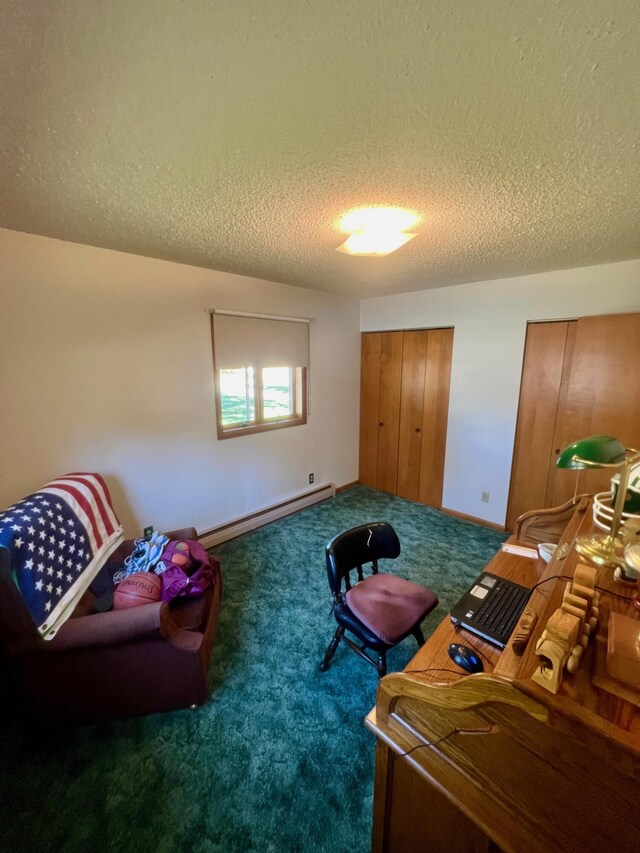 sitting room with a baseboard heating unit, a textured ceiling, carpet floors, and baseboards