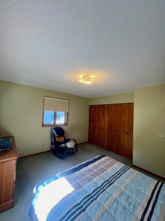 unfurnished bedroom with a textured ceiling, baseboards, and light carpet