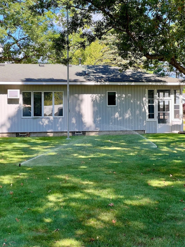 rear view of property with a yard