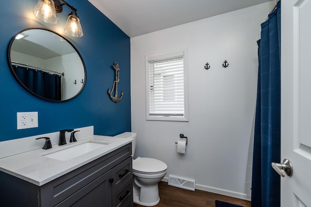 6950 Shore Dr, Coloma, MI 49038 - full bathroom featuring wood finished floors, toilet, vanity, baseboards, and visible vents