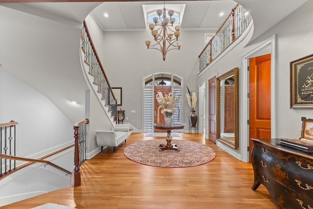 entryway featuring wood finished floors, a chandelier, arched walkways, and stairs