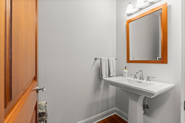 bathroom featuring baseboards and wood finished floors