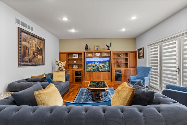living area with visible vents, wood finished floors, and recessed lighting