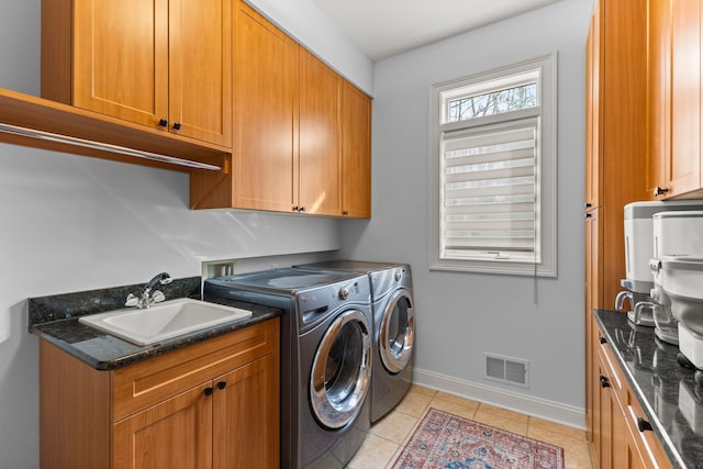 laundry room with separate washer and dryer, light tile patterned floors, a sink, baseboards, and visible vents
