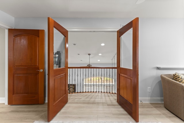 hall with recessed lighting, baseboards, and light wood-style floors