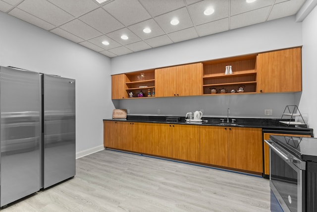 kitchen with dark countertops, recessed lighting, open shelves, and stainless steel appliances