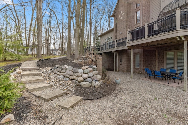 view of yard featuring a patio and a deck