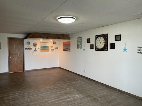9015 Kingsley Dr, Onsted, MI 49265 - finished below grade area with dark wood finished floors and baseboards