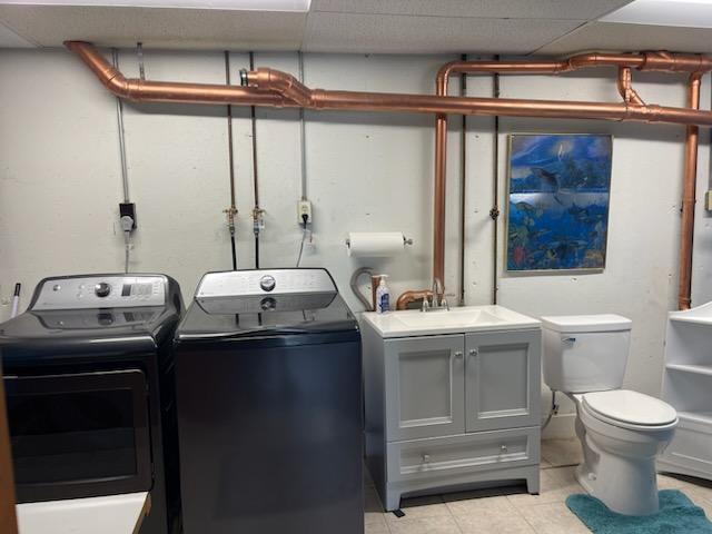 9015 Kingsley Dr, Onsted, MI 49265 - washroom with light tile patterned flooring, washing machine and clothes dryer, laundry area, and a sink