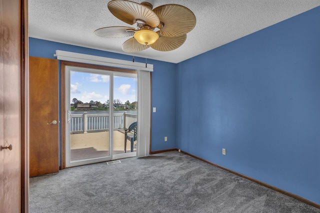 9015 Kingsley Dr, Onsted, MI 49265 - carpeted empty room featuring a textured ceiling, ceiling fan, baseboards, and visible vents