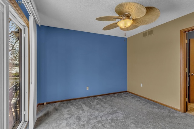 9015 Kingsley Dr, Onsted, MI 49265 - carpeted empty room with a textured ceiling, visible vents, a ceiling fan, and baseboards