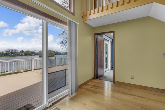 9015 Kingsley Dr, Onsted, MI 49265 - doorway featuring light wood finished floors, a water view, and baseboards