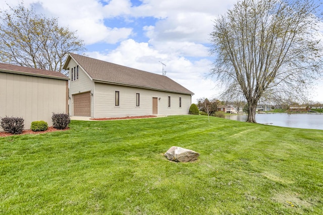 9015 Kingsley Dr, Onsted, MI 49265 - rear view of property with a yard, a water view, and a garage