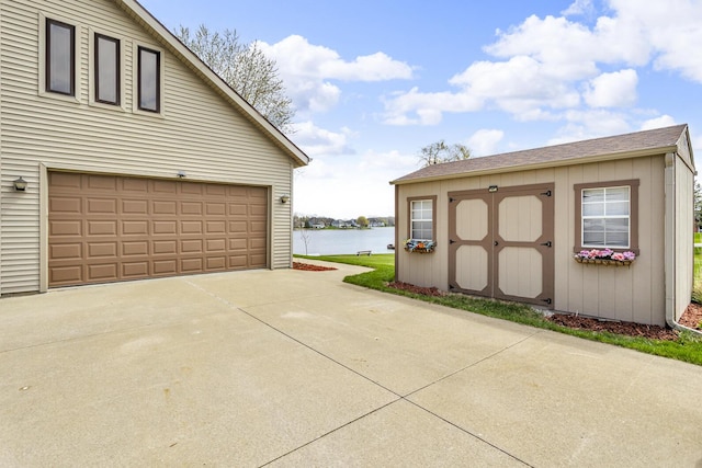 9015 Kingsley Dr, Onsted, MI 49265 - garage with a storage shed and a water view