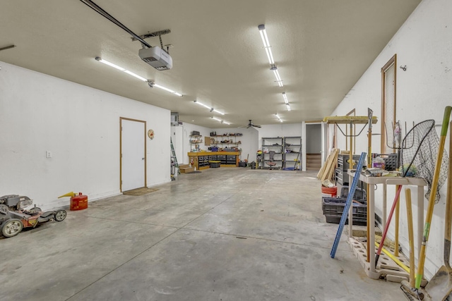 9015 Kingsley Dr, Onsted, MI 49265 - garage featuring a garage door opener and a workshop area