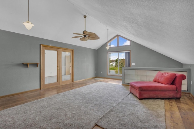 9015 Kingsley Dr, Onsted, MI 49265 - sitting room featuring wood finished floors, ceiling fan, baseboards, vaulted ceiling, and french doors