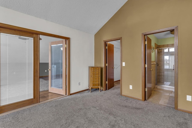 9015 Kingsley Dr, Onsted, MI 49265 - unfurnished bedroom with access to outside, vaulted ceiling, baseboards, a textured ceiling, and carpet floors